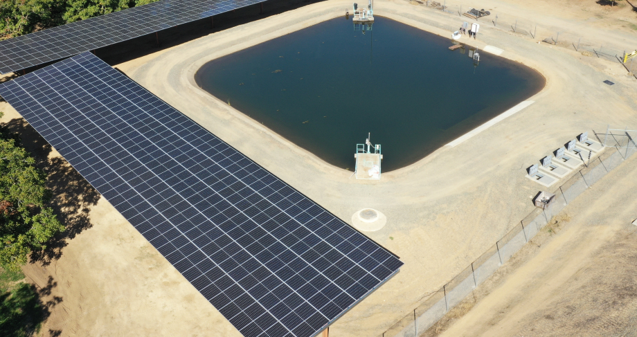 Aerial view of solar power plant with body of water