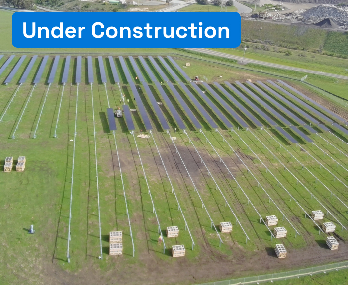 Aerial view of solar plant in a green field.