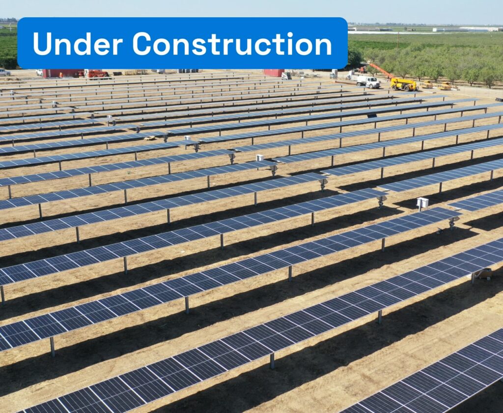 Overview of a solar panel plant on arid terrain.